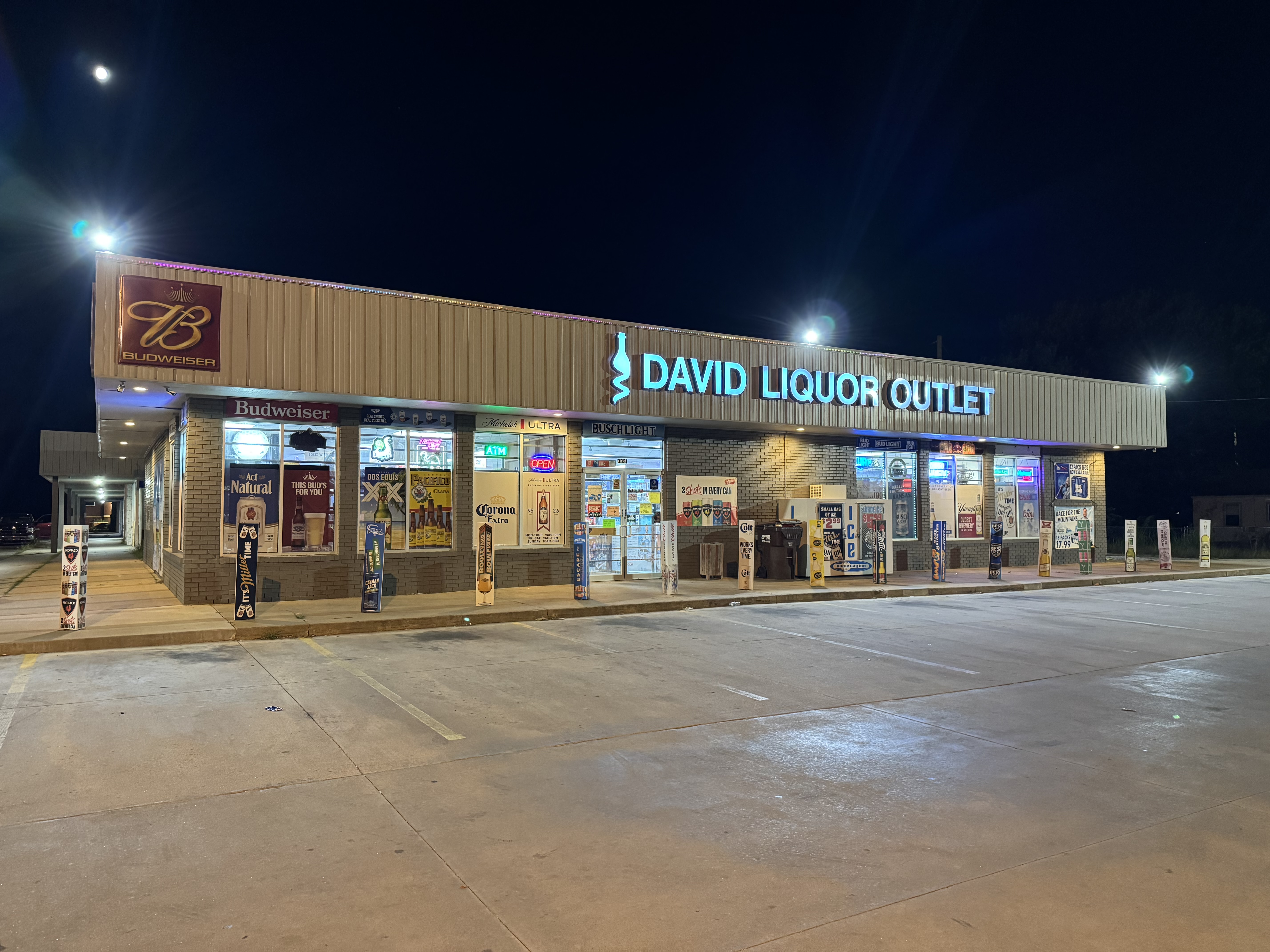 David Liquor Outlet illuminated storefront in Wichita at night